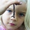 Child blond girl holding earthworm