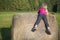 Child blond Girl by straw hay bale in field