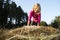 Child blond Girl by straw hay bale in field