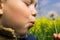 Child blowing a dandelion