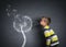 Child blowing dandelion seeds