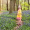 Child with bluebell flowers in spring forest