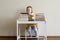 A child between books at the children`s table