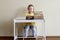 A child between books at the children`s table