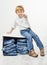 Child on box with jeans. Showing thumbs up