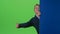 Child boy appears from the side board waving hand and calling to his on a green screen