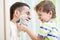 Child boy attempting to shave his dad