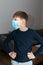 Child boy in blue medical mask in coronavirus quarantine at home. Epidemic control of COVID19 and proper prevention of
