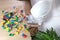 Child, a boy in a builder`s helmet plays with colored wooden cubes, builds houses and rockets, the concept of the development of