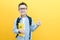 Child boy in glasses isolated on yellow paper wall. Great idea. Happy smiling schoolboy goes back to school. Success, motivation,