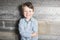 Child boy on grunge wooden background