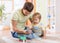 Child boy and his father repair toy car at home