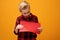 Child boy holding a red sign with space for text.