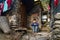 Child boy looking at camera near his poverty house in Kullu in higher part of town