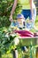 Child boy and mother in domestic garden. Adorable kid standing near the wheelbarrow with harvest. Healthy organic