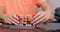 Child boy playing and building with colorful plastic bricks at the table