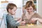 Child boy playing with education toys at the table in kindergarten