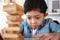Child Boy Playing Jenga Game Exciting on Desk at Home. Unleashing Fun and Skill. Careful and Attentive Keeping, Concentrate and