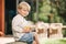 Child boy porch outside with glass lemonade