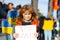 Child boy with poster with banner of russia conflict, military protest. America stand with Ukraine. Child with message