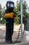 A child, a boy pretends to weld a fence. Welder`s costume, gloves, mask.