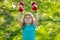 Child boy raising a dumbbell. Cute child training with dumbbells. Children fitness. Kid boy exercising with dumbbells