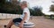 Child boy spinning on swing in public park and laughing on evening