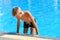 Child boy swimmer. The boy in the pool at the hotel. Sports holiday with children at the resort.