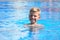 Child boy swimmer. The boy in the pool at the hotel. Sports holiday with children at the resort.