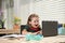 Child boy using a laptop and study online lesson. Pupil at school. Cute child using laptop computer, studying online.