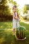 Child boy wash a watermelon under the hose in the back yard