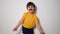 Child boy in a yellow T-shirt and black mustache dancing