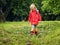 The child in bright rubber boots and a jacket