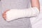 A child broken arm in plaster case, hand injury because of accident, forearm bones fracture