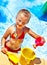 Child with bucket in swimming pool.