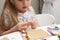 Child builds with constructor bricks, plays with toys, blurred background