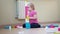 The child builds a tower of colored blocks. Cute little girl playing with colorful construction plastic blocks on the