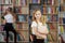 Child buys books in bookstore for learning or reading. Girl choosing book in school library