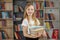 Child buys books in bookstore for learning or reading. Girl choosing book in school library