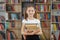 Child buys books in bookstore for learning or reading. Girl choosing book in school library