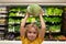 Child with cabbage. Kid in a food store or a supermarket. Little kid going shopping. Healthy food for kids.