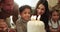 Child, candles and blow at birthday cake with family love at Jewish celebration, party together for son development