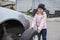 A child in a car service, on the replacement of tires and after-sales service of the vehicle.  Auto repair concept