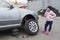 Child at a car service. Replacing wheels on a car. Repair service