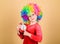 Child care. Happy moments. Kid hold alarm clock. Stop being so serious. Girl cute playful kid wear curly rainbow wig