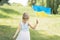 Child carries fluttering blue and yellow flag of Ukraine in field. Ukraine`s Independence Day. Flag Day. Constitution day. Girl i