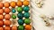 A child of Caucasian nationality paints small clouds of quail eggs with a metal spoon and lowers