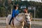 Child with cerebral palsy receiving equine therapy