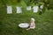 A child cheerfully launderes his clothes in the basin.Spray water and foam from washing clothes.