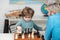 Child and childhood. Clever concentrated and thinking child while playing chess. Games and activities for children